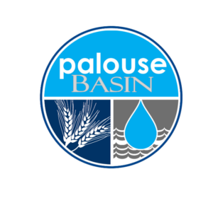 Palouse Basin Water Summit logo, which is a circle with a light blue top half with the words "Palouse Basin" and the bottom half separated in two with a dark blue side with a white wheat silhoutte, and a gray side with water waves and a blue water drop.