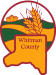 Whitman County logo - a yellow with red border shape mimicking whitman county, with a circle in the background with yellow and green fields with wheat in the foreground and three silos in the background